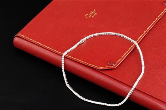 A modern Cartier 18ct white gold and diamond line choker necklace, with Cartier box and certificate dated 14/3/03, 37.5cm.